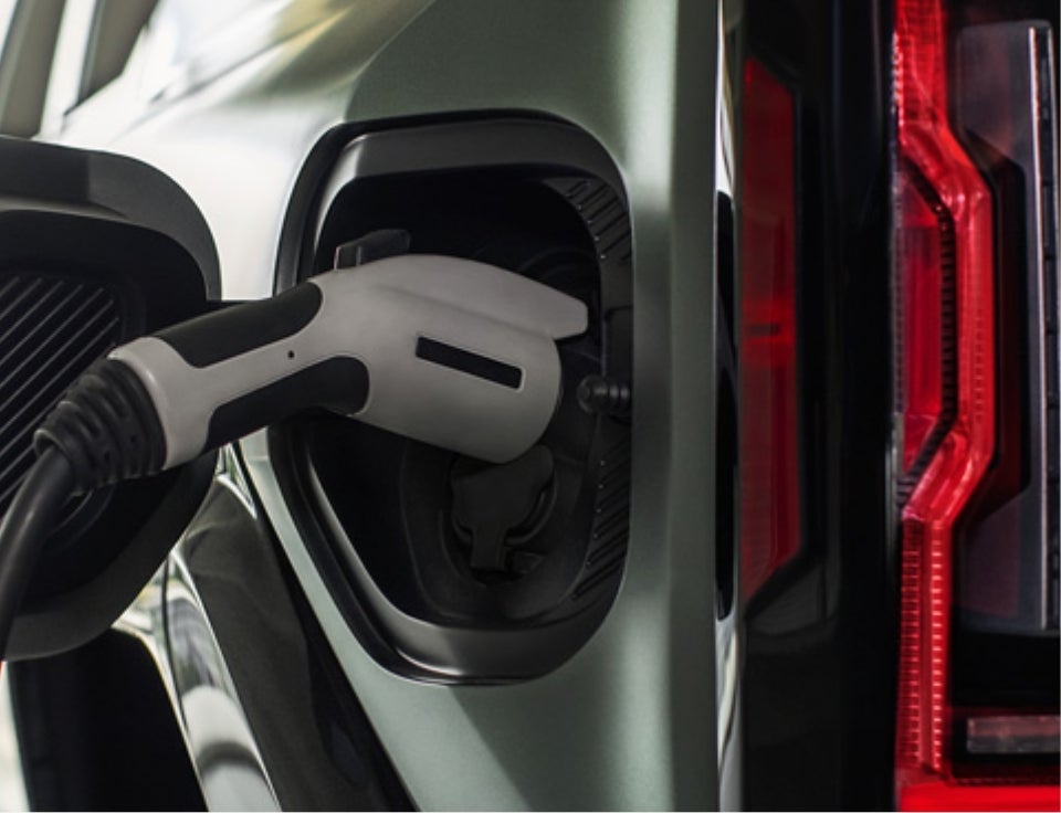Close up of charging port with charger plugged in on a GMC Hummer EV SUV - Steinle GMC Cadillac in Fremont OH